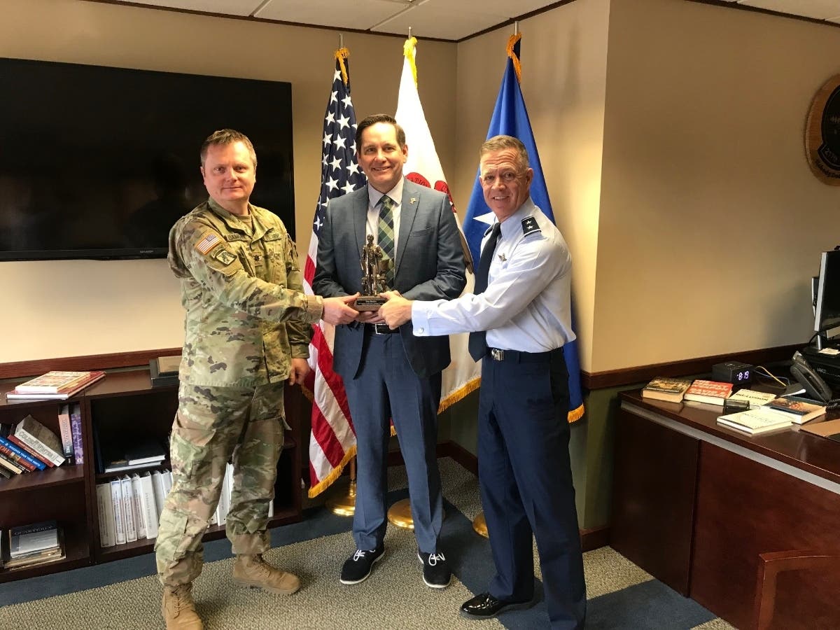 State Rep. Tim Butler (center) receives the National Guard Association of Illinois’ Abraham Lincoln Award from members of the Illinois National Guard. 
