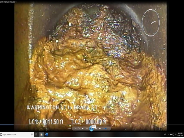 A mass of solidified grease and other debris led to the sewage backup on Brazil St.