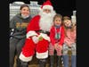 Left to right: Amelia Auten (Gr. 6), Nora Auten (K) and Stassi Tsichlas (K) visit with Santa. 