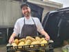 Chef Randall of Walter Stewart's Market happily receives the harvest he will be preparing Delicata Squash grown by Smith's Acres of Niantic. Blue Gold Potatoes grown by Gazy Brothers Farm of Oxford.