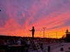 Drum Major Evangeline Gosselin conducts at sunset as the band rehearses in a NAHS parking lot.  