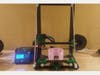 3D printer with a 8 stack of face shields on the build plate