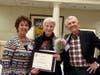 Dorothy Gaboda accepts the Women Helping Women Award from Kathy Meyer, past SIIR President, with her husband, Bill.