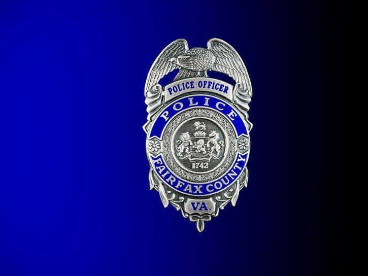 Police say a driver sitting at a stop sign in Herndon was assaulted and robbed by six men.
