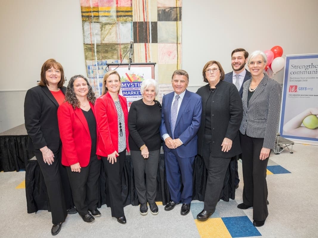 Local and state officials celebrated the opening of the Mystic Community Market Friday.