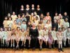 [Karen Lauria Saillant with children and other creators in a Holocaust performance]