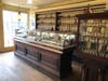 Glass cases display various items either sold at the Cody Drug Store or used by employees.