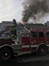 Firefighters worked to extinguish a roof fire at the Rowayton Woods Condominiums in Norwalk on March 27, 2019.