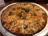 A Colony pizza with hot oil, sausage and light onion.