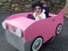 Sam Buck, 9, a wheelchair-bound Greenwich child with a rare brain disorder, dresses as Elvis riding in a pink Cadillac for Halloween.