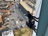 New York Yankees General Manager Brian Cashman rappels down the Landmark Building in Stamford with Jason Teitelbaum on Dec. 6, 2019.