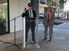 Tom Rich, of F.D. Rich Company, shows off a door knob while Mayor Harry Rilling listens during a ribbon cutting ceremony Wednesday at Harbourside SoNo.