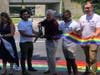 Mayor Harry Rilling cuts a rainbow ribbon during the unveiling of a new rainbow crosswalk in Norwalk on Tuesday.