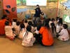 Students from the Maritime Odyssey Preschool listen to a story at the Maritime Aquarium's new Sea & Discover Zone after a ribbon cutting event Wednesday at the aquarium in Norwalk.