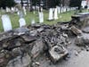 The damaged stone wall alongside St. Paul's on the Green Episcopal church's historic cemetery on East Avenue in Norwalk on Sunday, April 3, 2022.