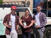 Hunter, Dana and Ben Patterson show off their bottles of Dos Hombres mezcal signed by "Breaking Bad" actors Aaron Paul and Bryan Cranston.