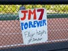 A sign honoring Jimmy McGrath, a 17-year-old Fairfield Prep student who was fatally stabbed late Saturday, hangs at Shelton High School.
