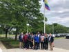 City officials, including Mayor Harry Rilling, stand in front of the raised Pride flag outside City Hall during a ceremony held Thursday afternoon.