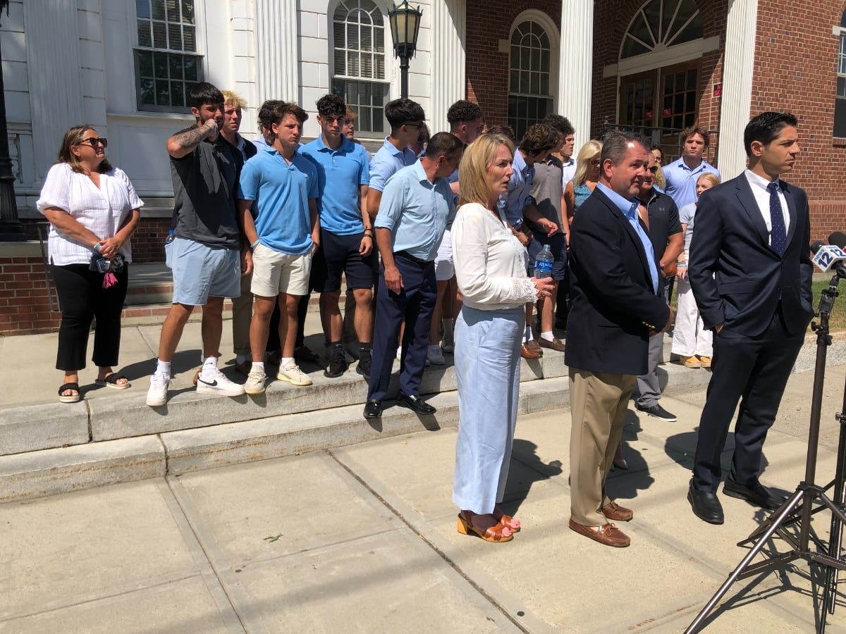Jimmy McGrath's parents, Kevin and Margaret, stand with a crowd of friends and family outside the Milford Courthouse on July 15, 2022.
