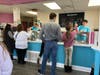Customers line up at Sweet Ashley's in Norwalk as they open for the 2023 season Wednesday.