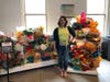 Rachel DeCavage stands in front of her coral reef sculptures made entirely of upcycled materials at the Maritime Aquarium in Norwalk on Thursday.
