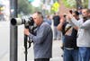 John Burgess, left, captures the capture of a mountain lion Monday morning in downtown Santa Rosa.