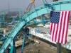 The "topping-out" ceremony included a crane placing an American flag at the ride's highest section.