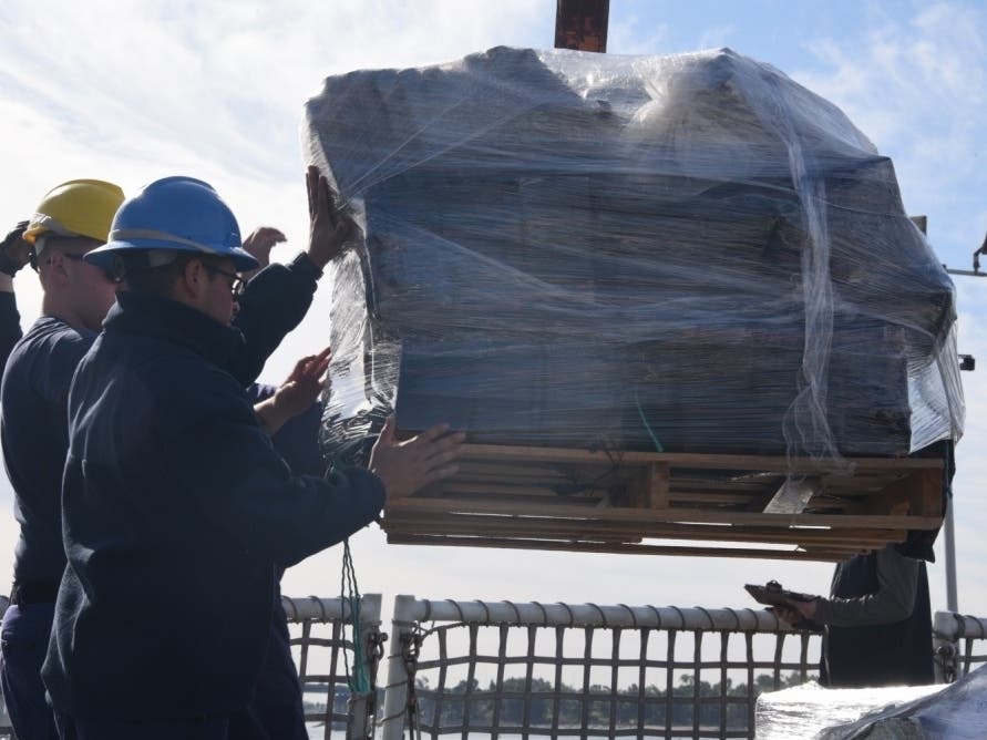 Coast Guard Cutter Bertholf (WMSL 750) crew members offload more than 18,000 pounds of cocaine in San Diego, Dec. 18, 2019.