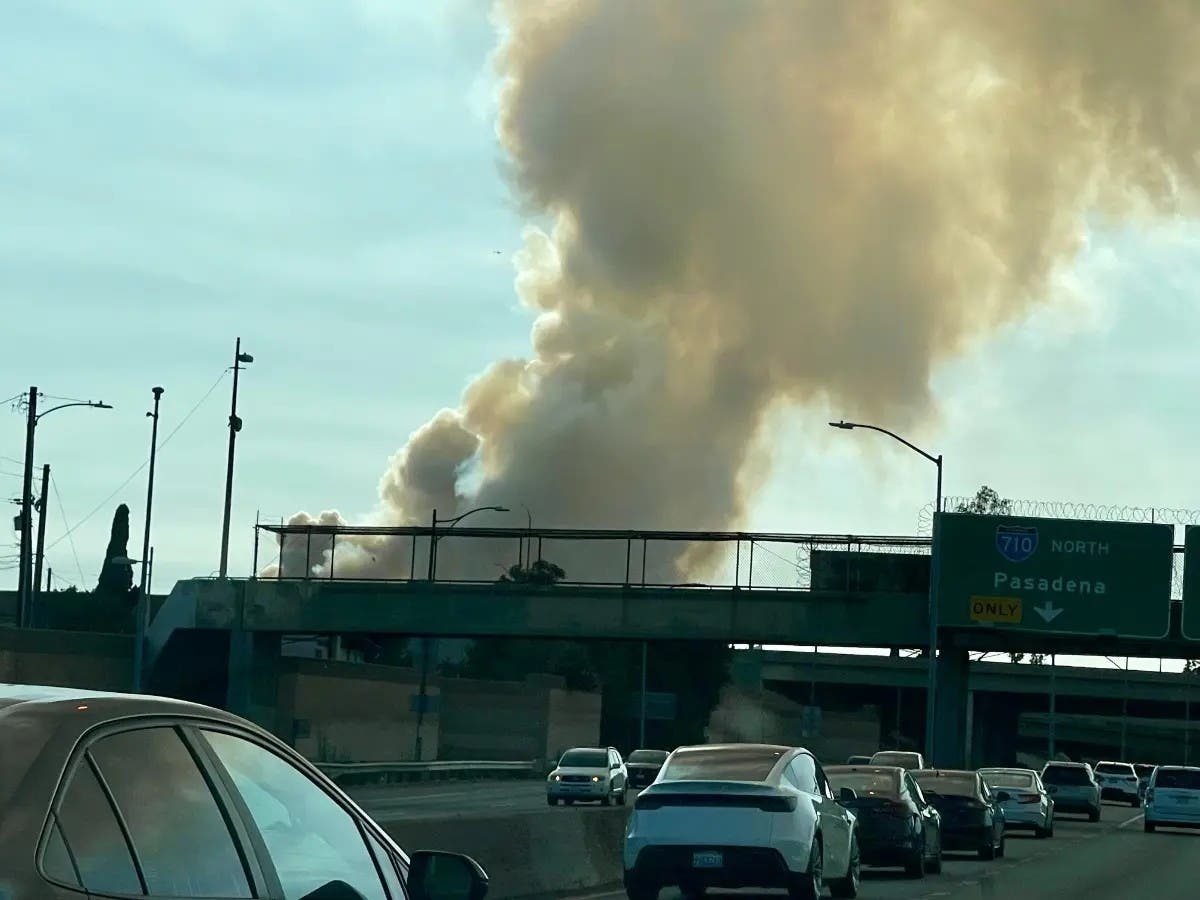 Smoke rises from the fire on Saturday afternoon, as viewed from the northbound 5 Freeway near the interchange with the 710 Freeway east of downtown Los Angeles.