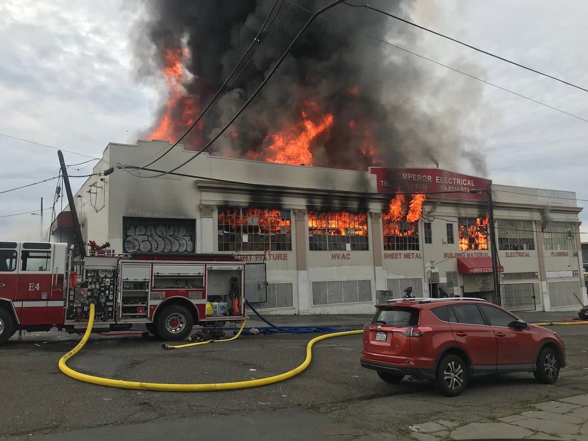 A black plume of smoke rose from the fire.