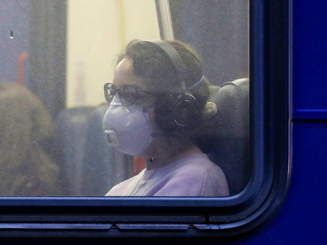 A commuter wears a mask to avoid coronavirus.