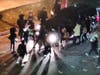 Protesters surround an SUV, holding the occupants prisoner and trying to open the driver's door.