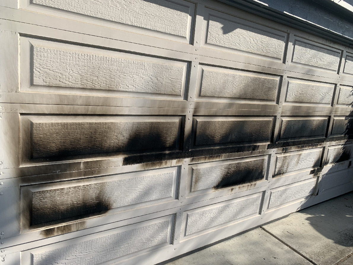 A garage door damaged by an arson fire in Fremont, Calif.