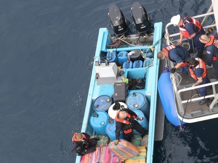 Crew members from the U.S. Coast Guard Cutter Munro (WMSL 755) take possession of a go-fast boat Feb. 6, 2021, in the Eastern Pacific Ocean. The crew recovered approximately 90 kilograms of suspected cocaine and 2,150 pounds of suspected marijuana. 
