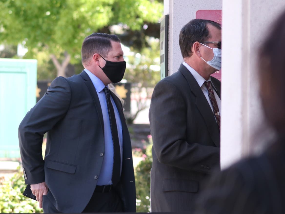 Danville Police Officer Andrew Hall, center, heads into his preliminary hearing at the A. F. Bray Courthouse in Martinez, Calif., on July 20, 2021 for the death of Laudemer Arboleda.