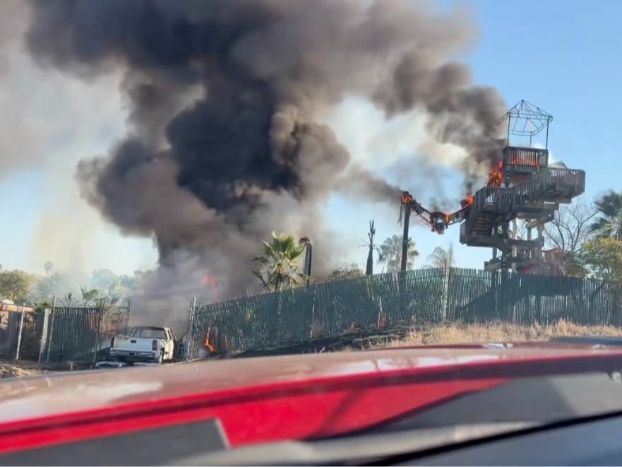 Firefighters said the blaze began when a truck crashed into a fence and the flames spread to nearby vegetation.