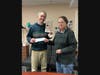 Justin Monroe, Director of Community and Environmental Projects, Grow Nashua accepts a donation from Mary Theresa Freund of the Nashua Garden Club.