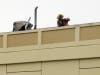 A firefighter takes evidence photos of the crash Wednesday.