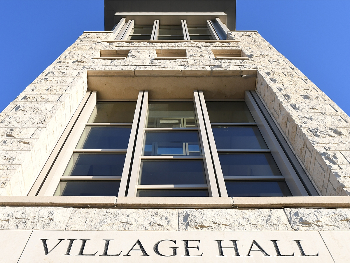 Looking up at the limestone tower of Village Hall