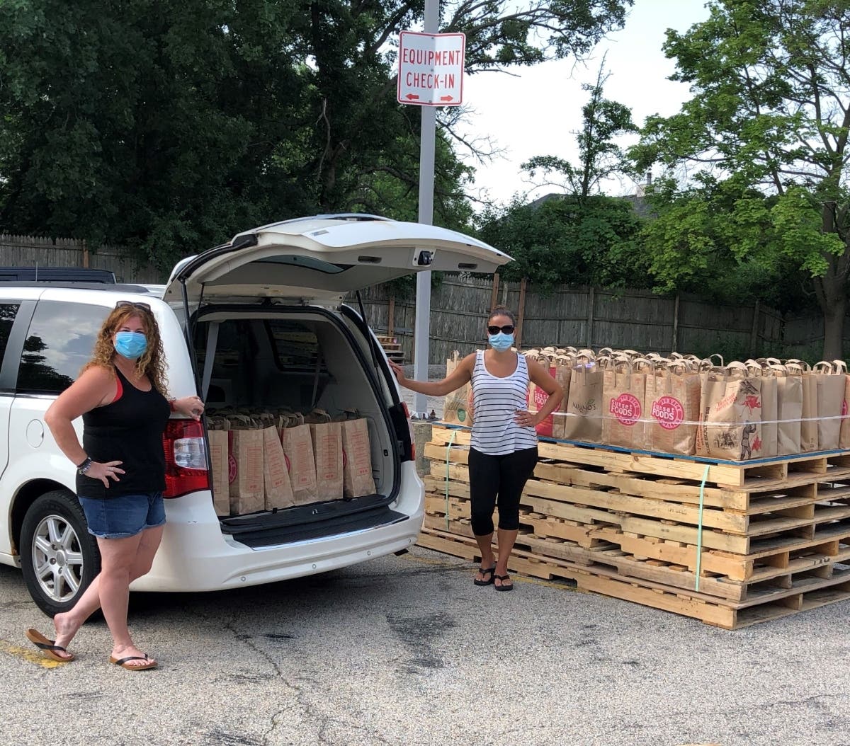 Field Middle School Social Worker Sandi Newman (left), and School Nurse Tania Gastelum, help collect food donations for the Hunger Resource Network.