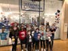 The NSYMCA Gymnastics team and coaches show off their projects in front of The Kindness Connection at Northbrook Court. 