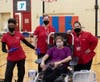 The American Red Cross team and a blood donor pose for a photo in the North Suburban YMCA Gym during a blood drive.