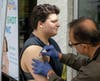 Asim Javed from Ascension Hospital administers a flu shot to a drop in Y member at the NSYMCA Flu Shot Clinic at the SeniorPalooza event held on September 13th.  