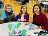 A Northbrook family makes personal messages for the “Blessing Bags” at the 2022 NSYMCA Holiday Giveback event. 