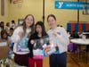 Caption:  Avery Atkinson, Mia Hong and Elle Mackey from the Northbrook Junior High School pack blessing bags at the NSYMCA for their student service hours