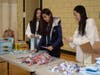 Caption:  Volunteers from the Northbrook Commission Youth Group, 1 For Community, help manage the tables and put supplies out for packing at the NSYMCA Holiday Giveback on Dec 9th.