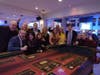 Caption: Casino participants enjoy a game of craps at the The North Suburban YMCA annual Community Strong Fundraising Dinner and Casino Night from 2023.