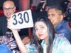 At the Din table, Northbrook resident Kruti Jain, raises her bidder number high and won a Live Auction Prize in effort to raise money for the North Suburban YMCA.