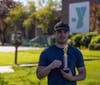 Caption: The runner with the fastest time at the NSYMCA Healthy Kids Day 5k run/walk shows off his trophy.