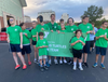 Caption: The NSYMCA Special Olympics Flying Turtles Swim Team gather at the Summer Games Opening Ceremony in Bloomington/Normal, Illinois, winning a total of 19 medals.